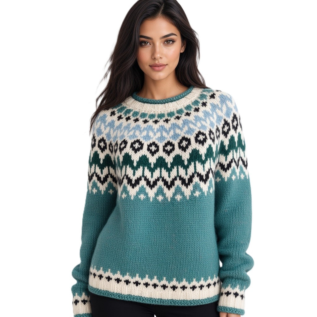 A woman modeling a teal Fair Isle knit sweater with cream, light blue, and black geometric patterns, set against a plain white background.