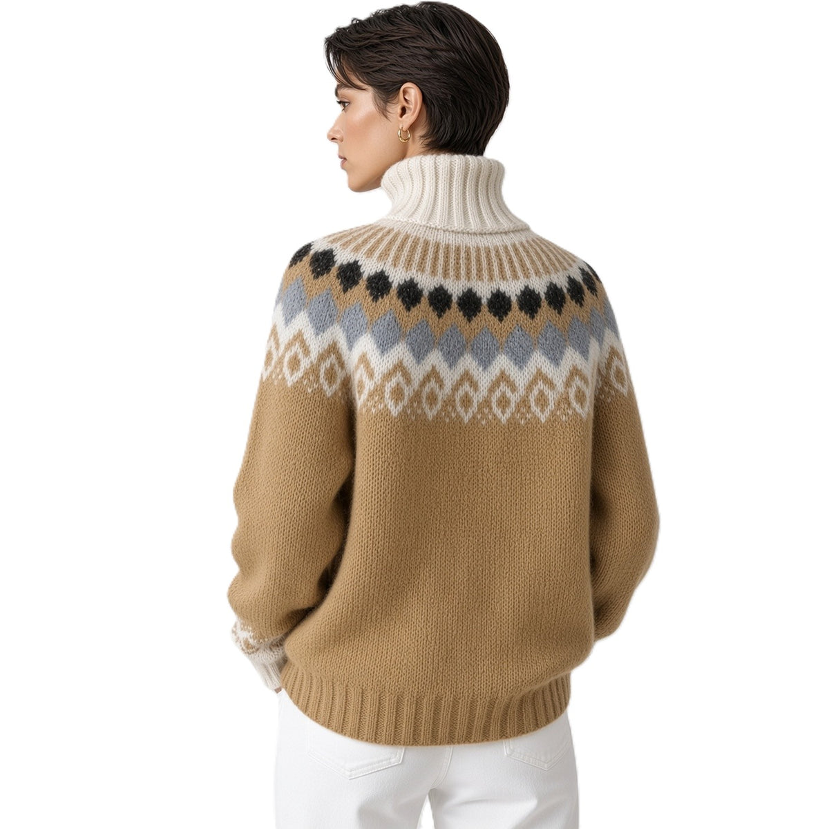 A woman shown from the back wearing a tan knit turtleneck sweater with a multicolor Fair Isle pattern across the shoulders and upper back, paired with white pants, against a plain white background.