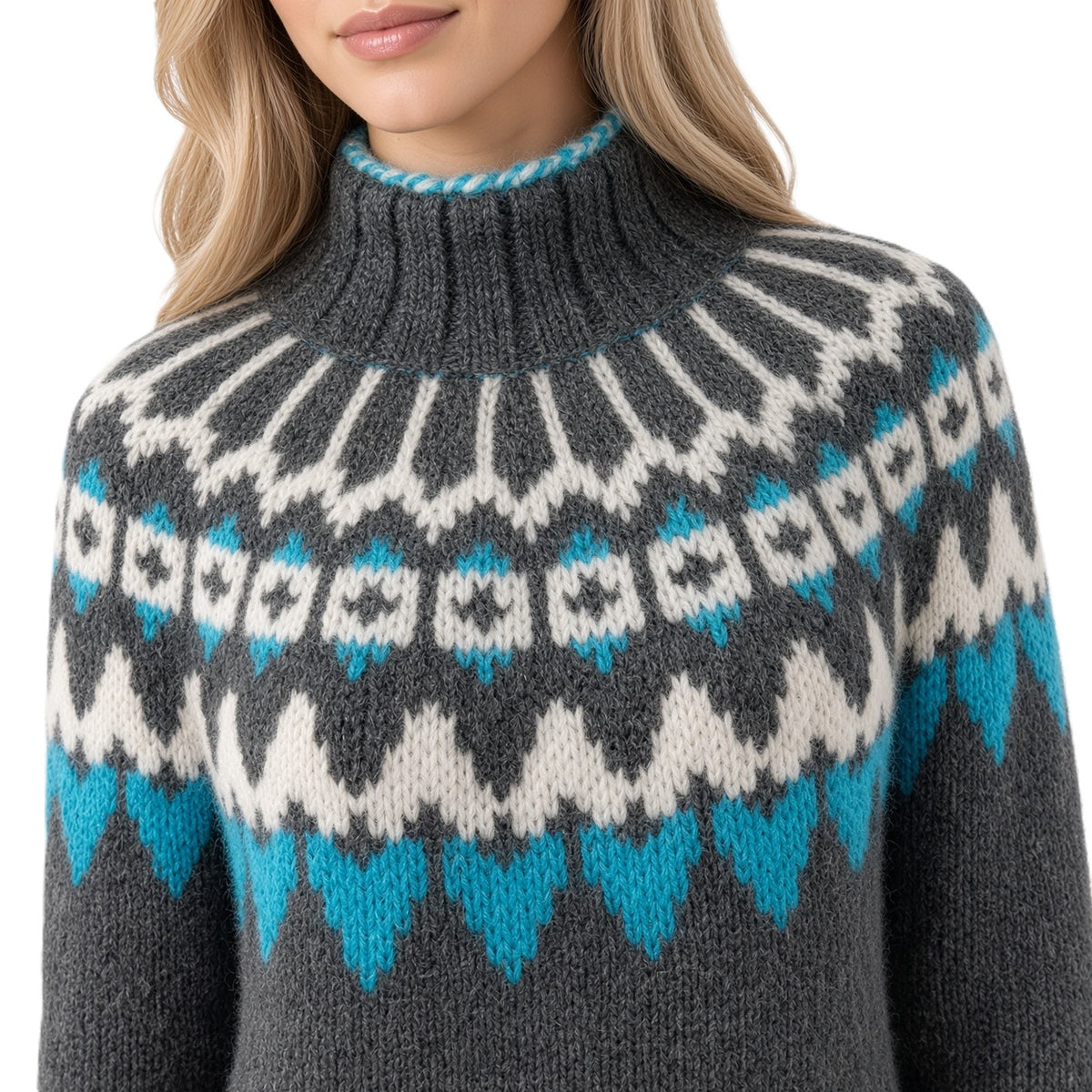 A close-up of a woman wearing a dark gray knit sweater with a high ribbed mock neck and a Fair Isle pattern in cream and turquoise blue.
