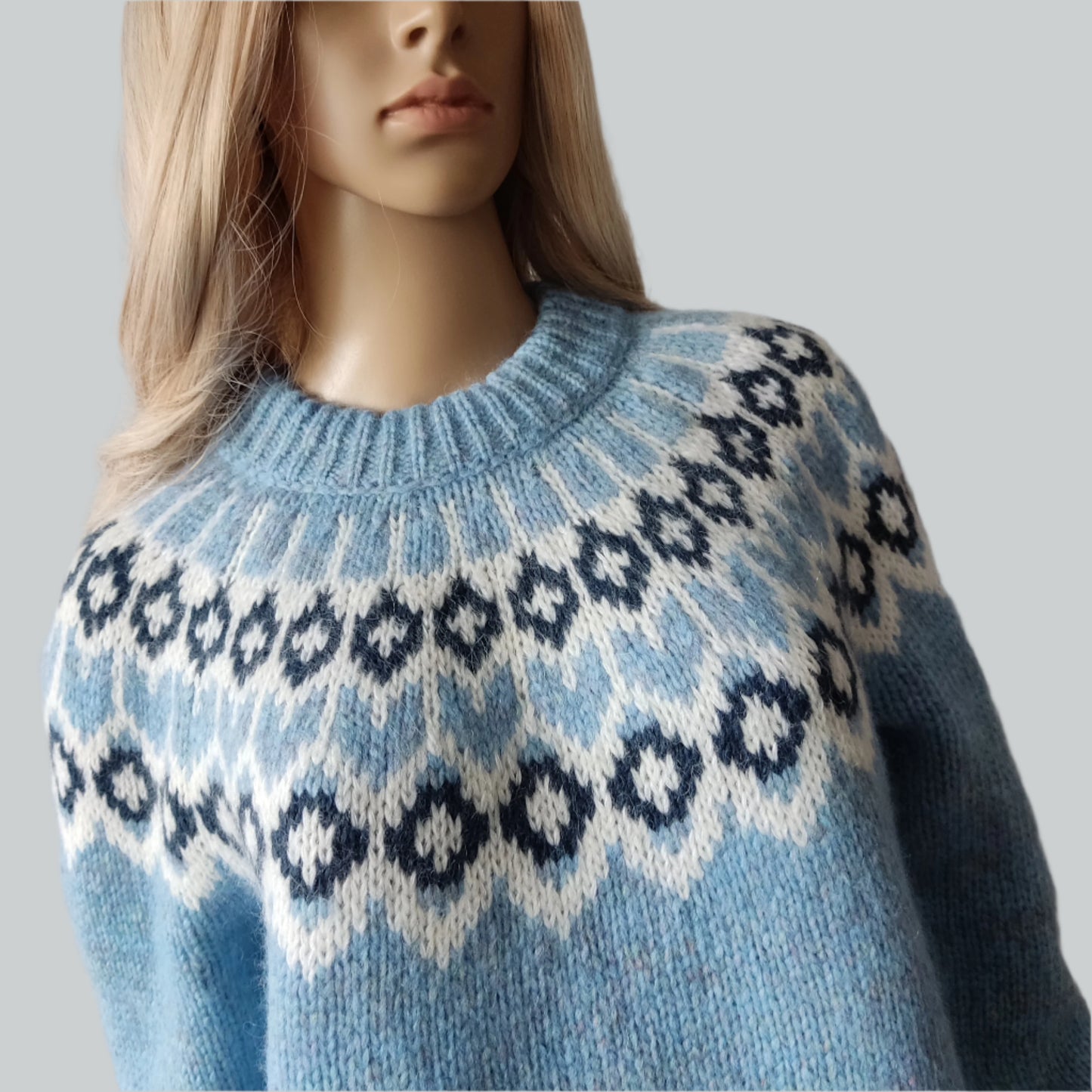 Hand-knitted light blue melange oversized unisex chunky knit Scandinavian sweater Lopapeysa Fair Isle with a white and navy Nordic round yoke, featuring a double collar, ribbed hem, and cuffs in light blue, made from soft hypoallergenic baby alpaca and extrafine merino wool.