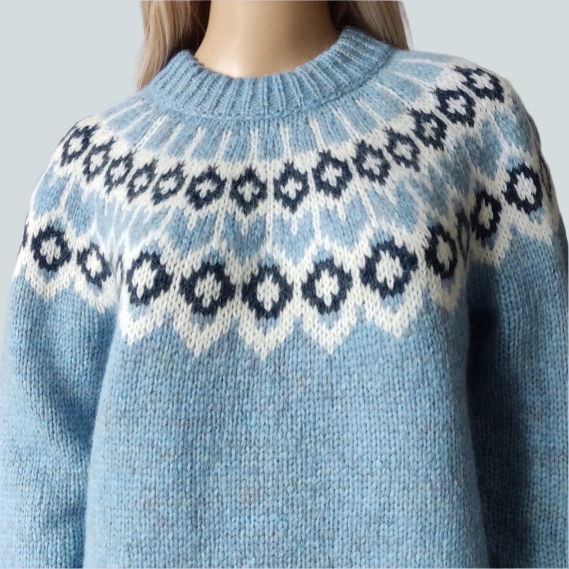 Hand-knitted light blue melange oversized unisex chunky knit Scandinavian sweater Lopapeysa Fair Isle with a white and navy Nordic round yoke, featuring a double collar, ribbed hem, and cuffs in light blue, made from soft hypoallergenic baby alpaca and extrafine merino wool.