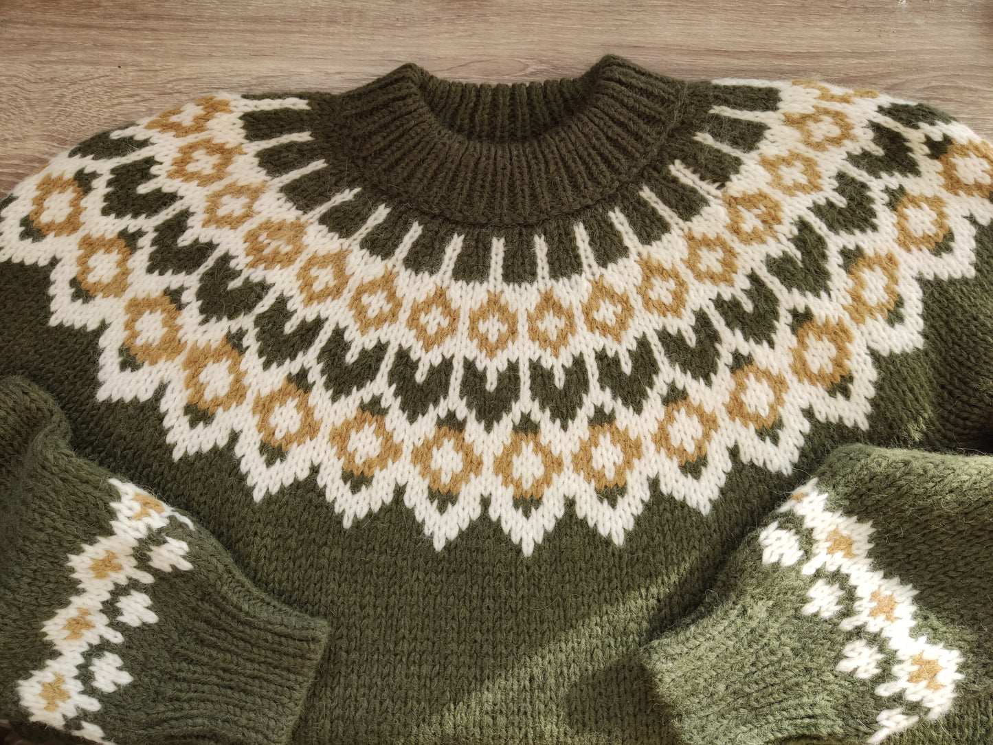 Hand-knitted olive green oversized unisex chunky knit Scandinavian sweater Lopapeysa Fair Isle with a cream and mustard Nordic round yoke, featuring a double collar, ribbed hem, and cuffs in olive, made from soft hypoallergenic baby alpaca and extrafine merino wool.