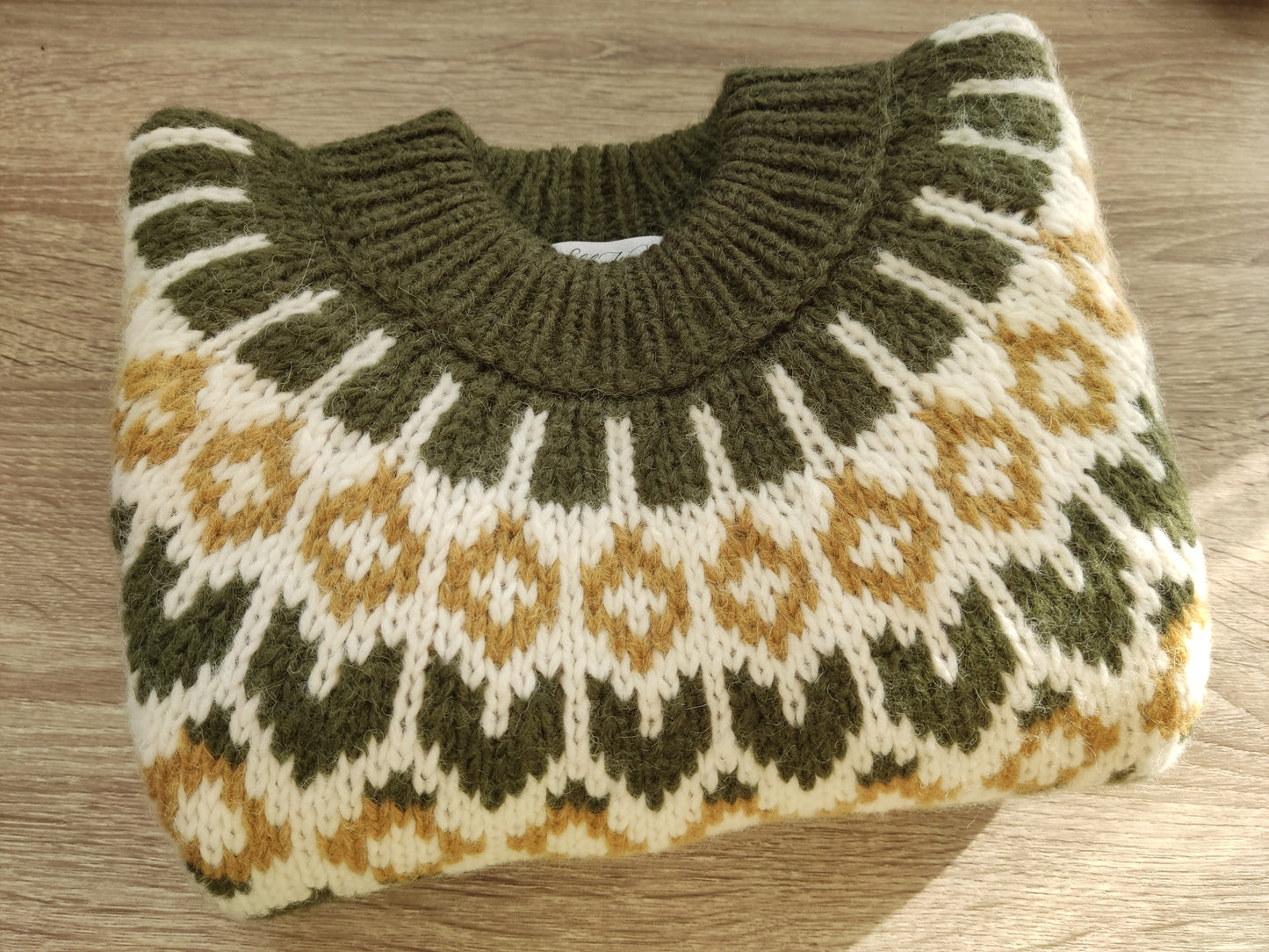 Hand-knitted olive green oversized unisex chunky knit Scandinavian sweater Lopapeysa Fair Isle with a cream and mustard Nordic round yoke, featuring a double collar, ribbed hem, and cuffs in olive, made from soft hypoallergenic baby alpaca and extrafine merino wool.