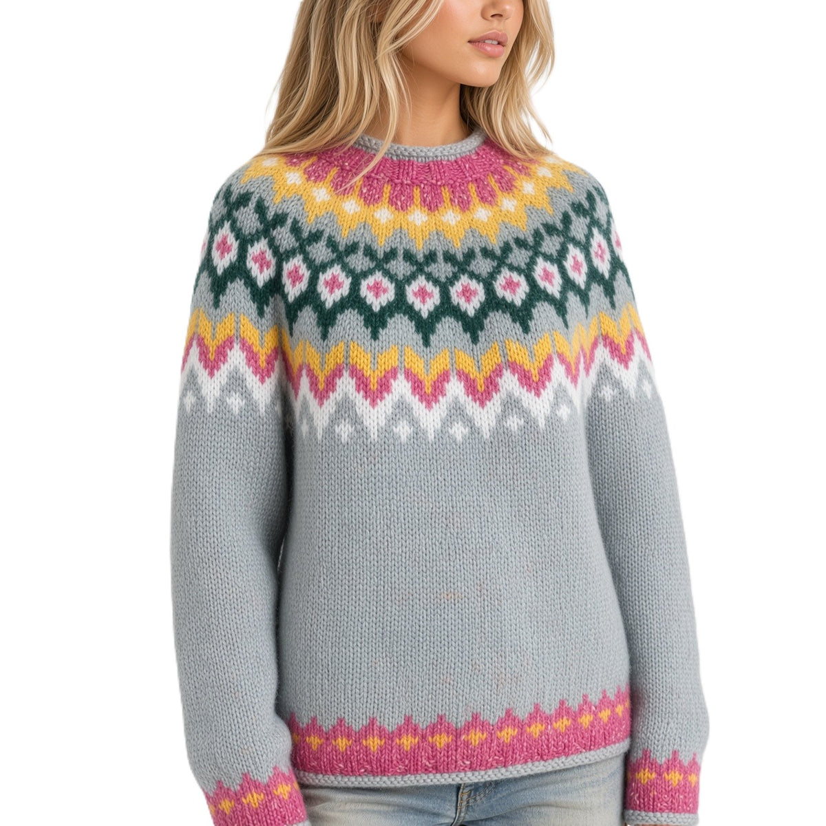 A woman wearing a pastel blue knit sweater with a colorful Fair Isle yoke pattern in pink, yellow, green, and white, paired with light blue jeans against a plain white background.