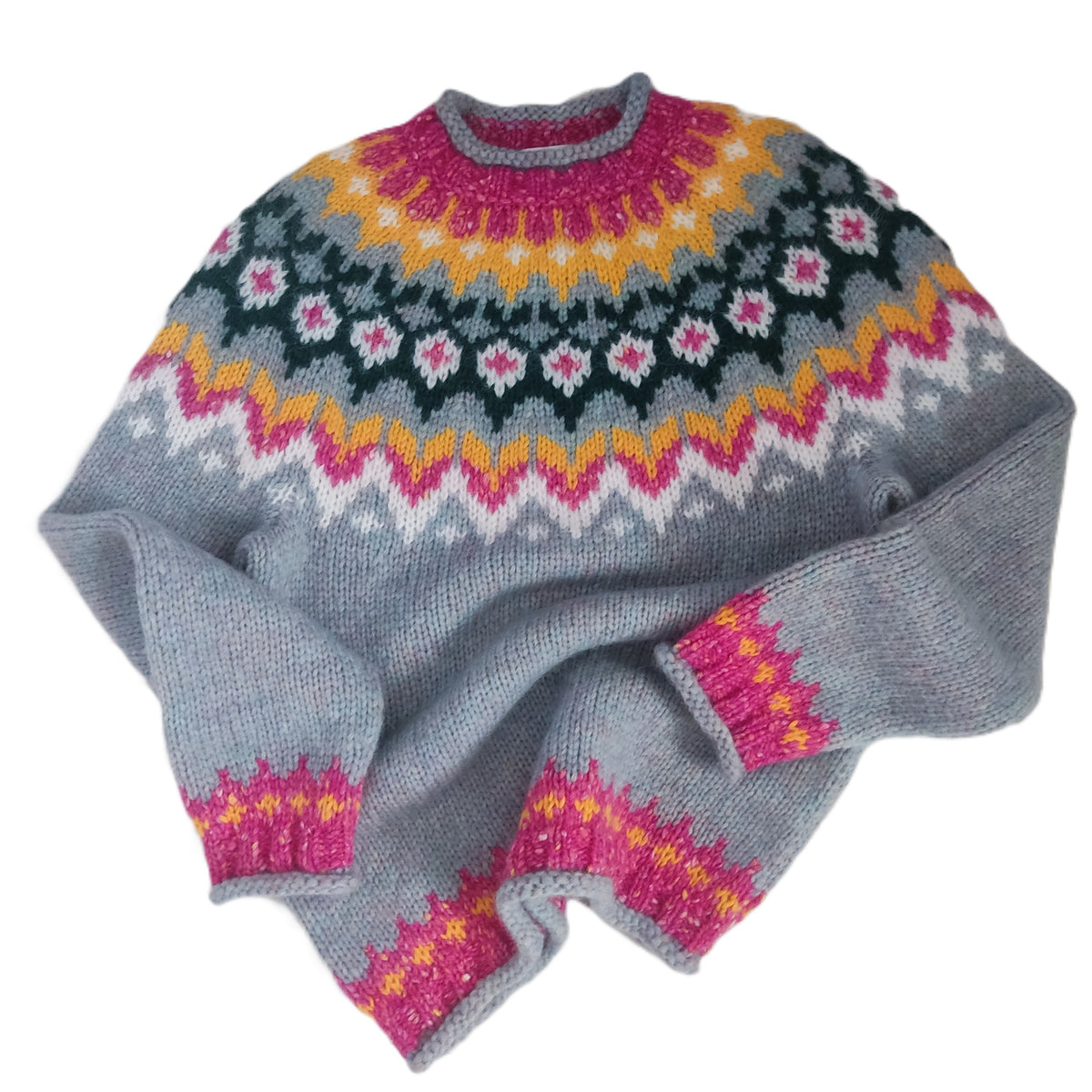 A pastel blue knit sweater with a colorful Fair Isle pattern in pink, yellow, white, and dark green, laid flat on a white background.