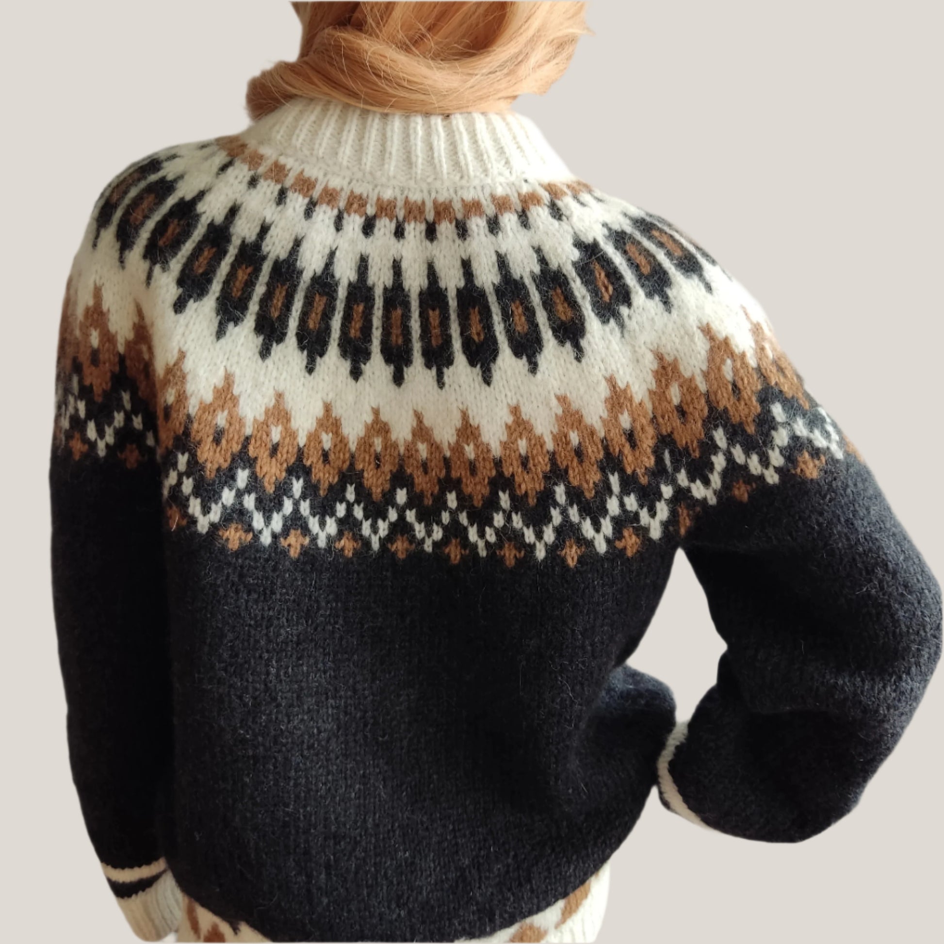 Hand-knitted black oversized unisex Scandinavian Lopapeysa sweater with a Nordic round yoke in white and taupe, featuring white ribbed cuffs, collar, made from soft hypoallergenic baby alpaca and merino wool.