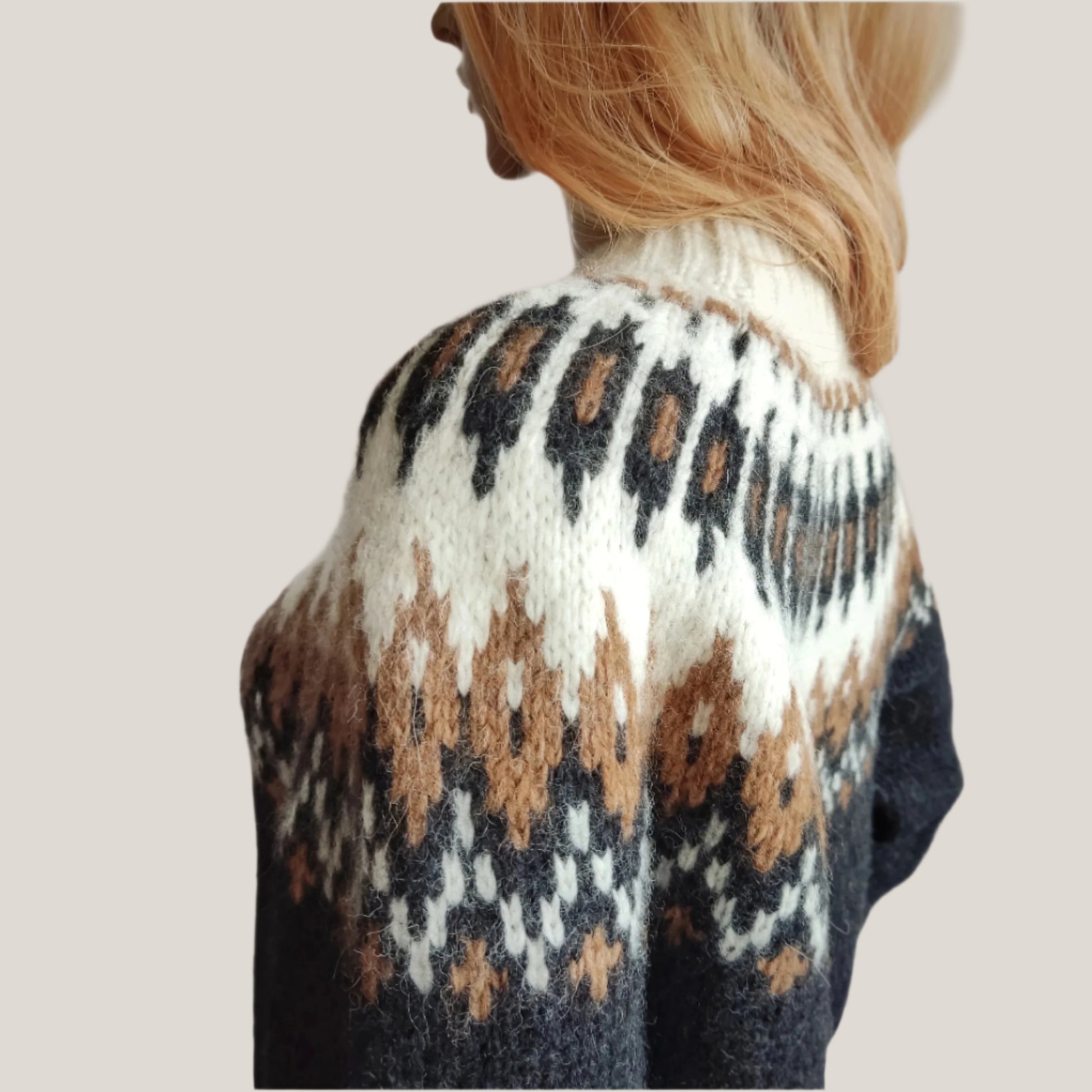 Hand-knitted black oversized unisex Scandinavian Lopapeysa sweater with a Nordic round yoke in white and taupe, featuring white ribbed cuffs, collar, made from soft hypoallergenic baby alpaca and merino wool.