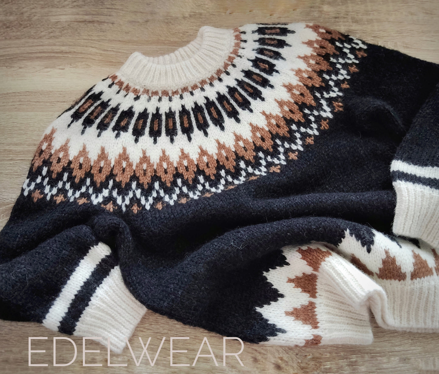 Hand-knitted black oversized unisex Scandinavian Lopapeysa sweater with a Nordic round yoke in white and taupe, featuring white ribbed cuffs, collar, made from soft hypoallergenic baby alpaca and merino wool.