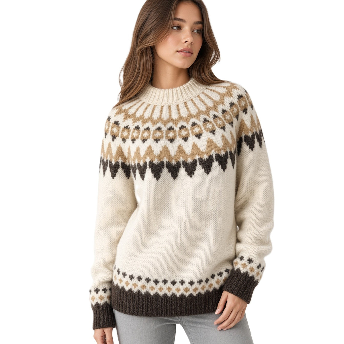 A woman wearing a cream-colored knit sweater with a brown and beige Fair Isle pattern across the chest and cuffs, paired with light gray jeans, against a plain white background.
