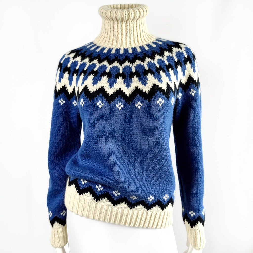 Hand-knitted blue oversized unisex Scandinavian Lopapeysa sweater with a chunky-knit white and navy Nordic round yoke, featuring a double crew neck, white ribbed cuffs, and hem, made from soft hypoallergenic baby alpaca and merino wool.