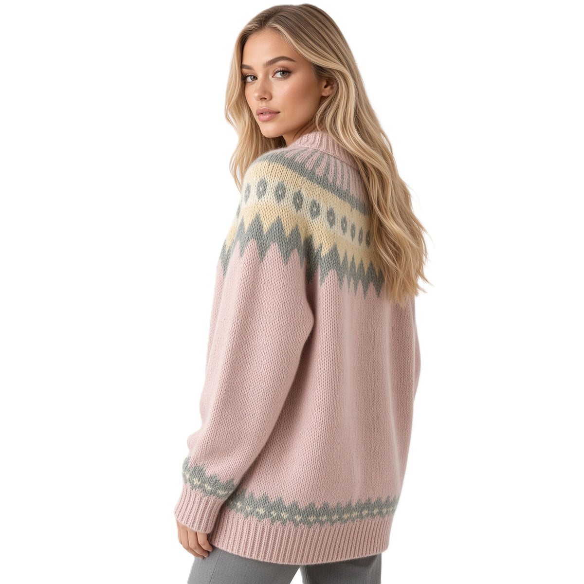 A woman modeling a pink knit sweater with a cream and gray Fair Isle pattern across the shoulders and sleeves, shown from a three-quarter back angle against a plain white background.