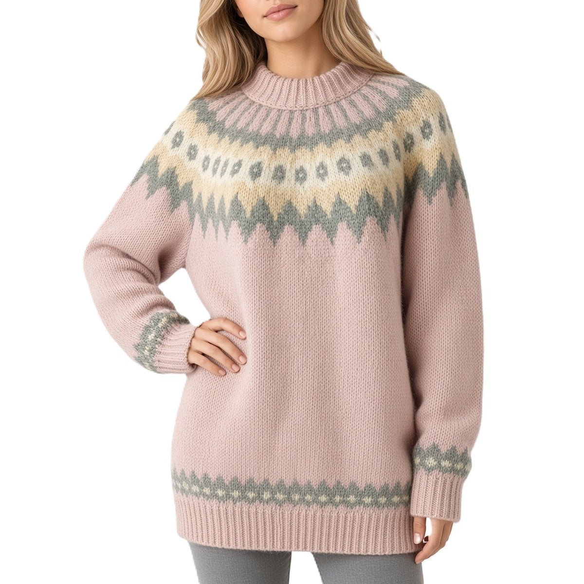 A woman wearing a pink knit sweater with a traditional Fair Isle pattern in beige and muted green, shown against a plain white background.