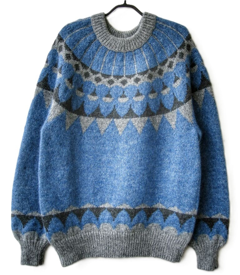 Blue and gray patterned sweater on a white background