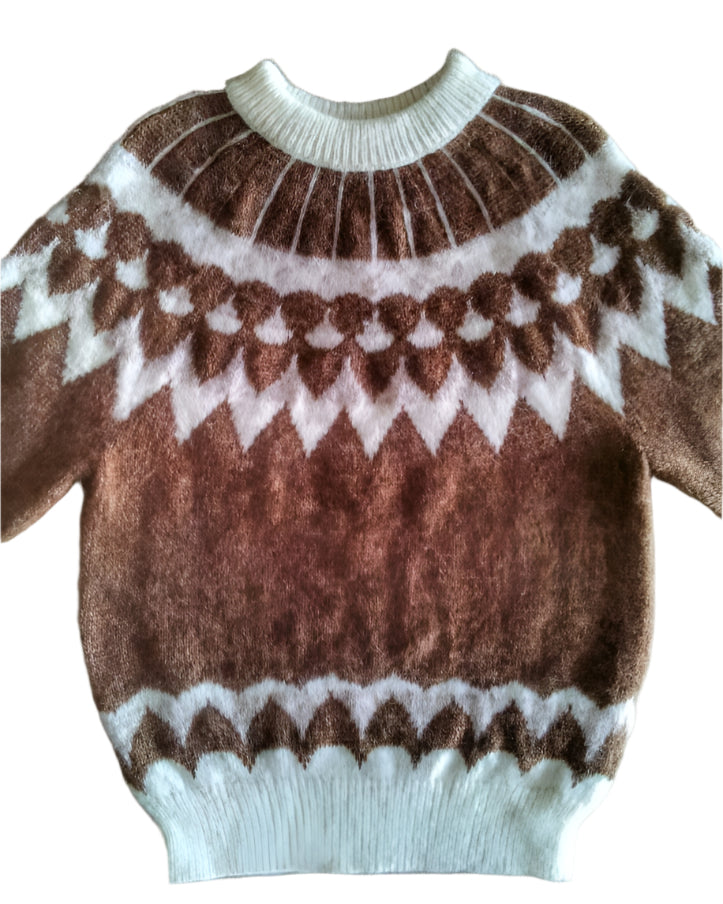 Brown and white patterned sweater on a white surface
