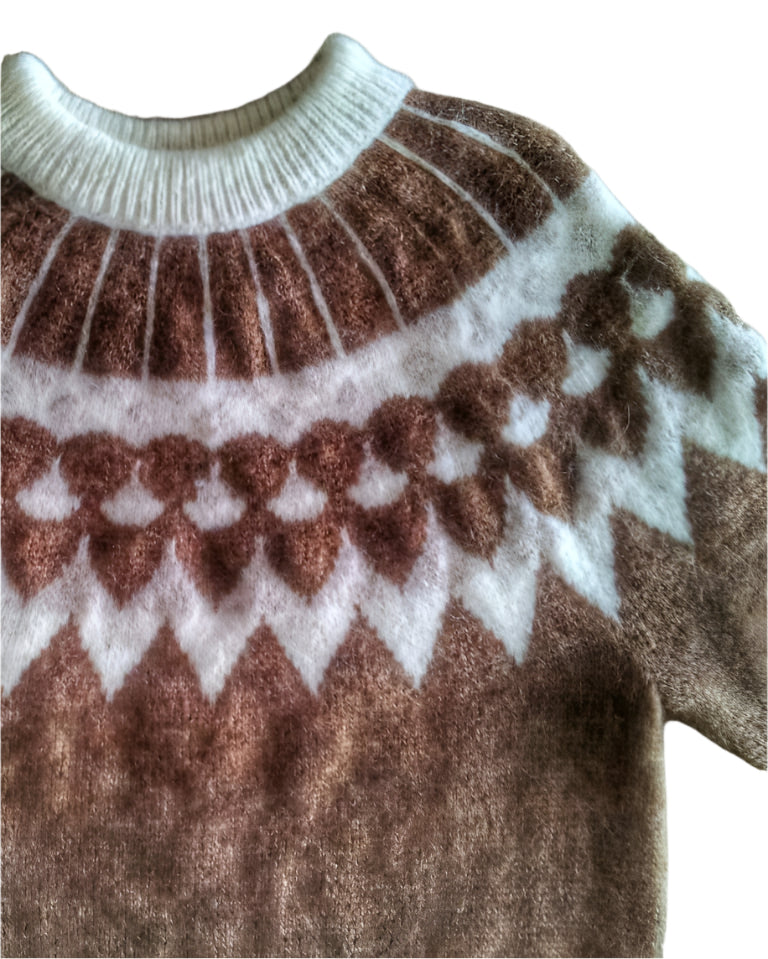 Brown and white patterned sweater on a white surface