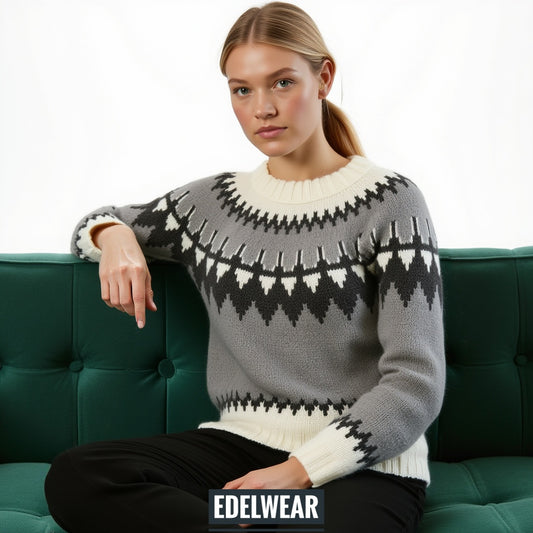 Hand-knitted gray chunky-knit women’s Scandinavian Lopapeysa sweater with a black and white Nordic round yoke, featuring white ribbed cuffs, round collar, and hem, made from soft hypoallergenic baby alpaca and merino wool.